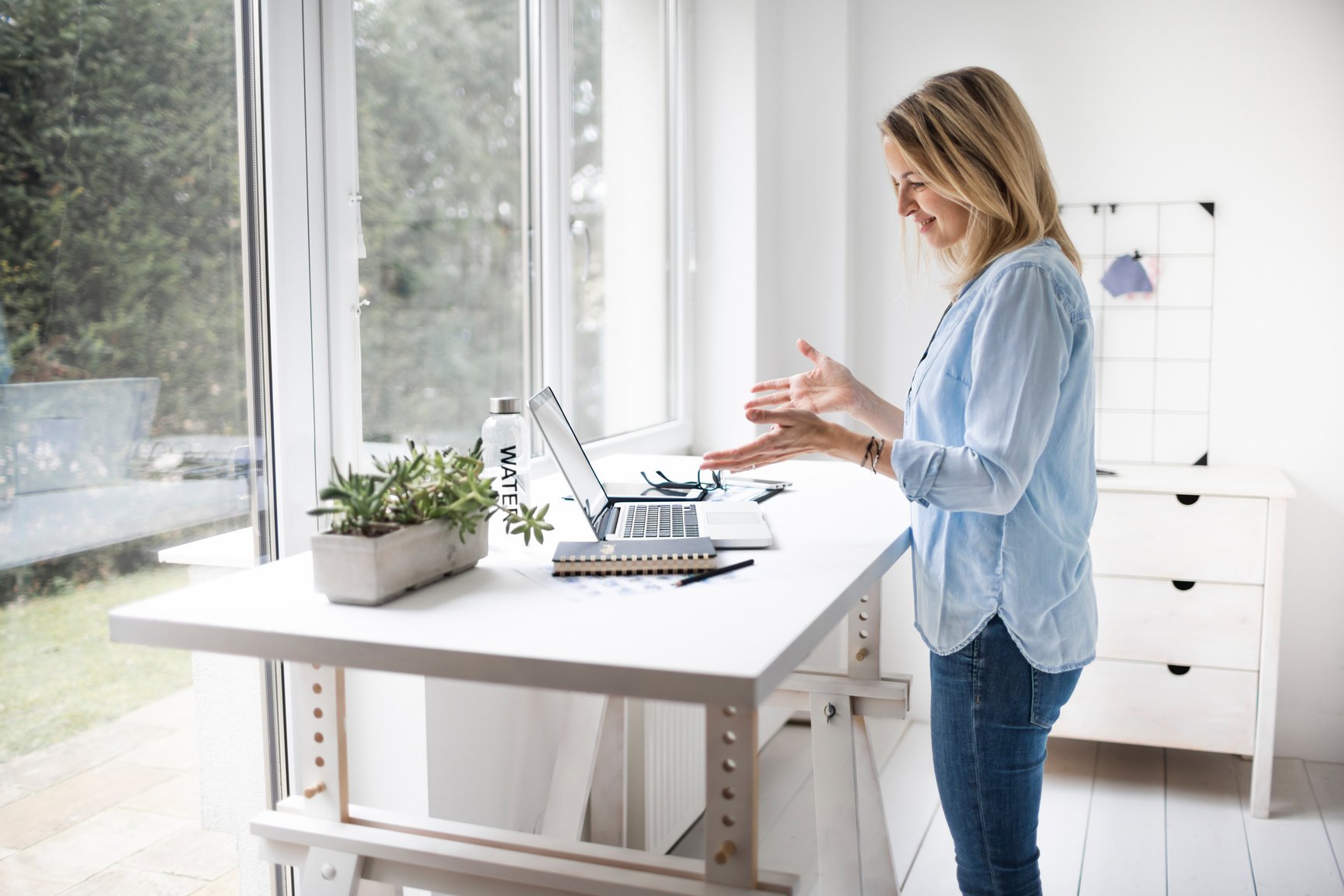 Businesswoman working at ergonomic standing desk